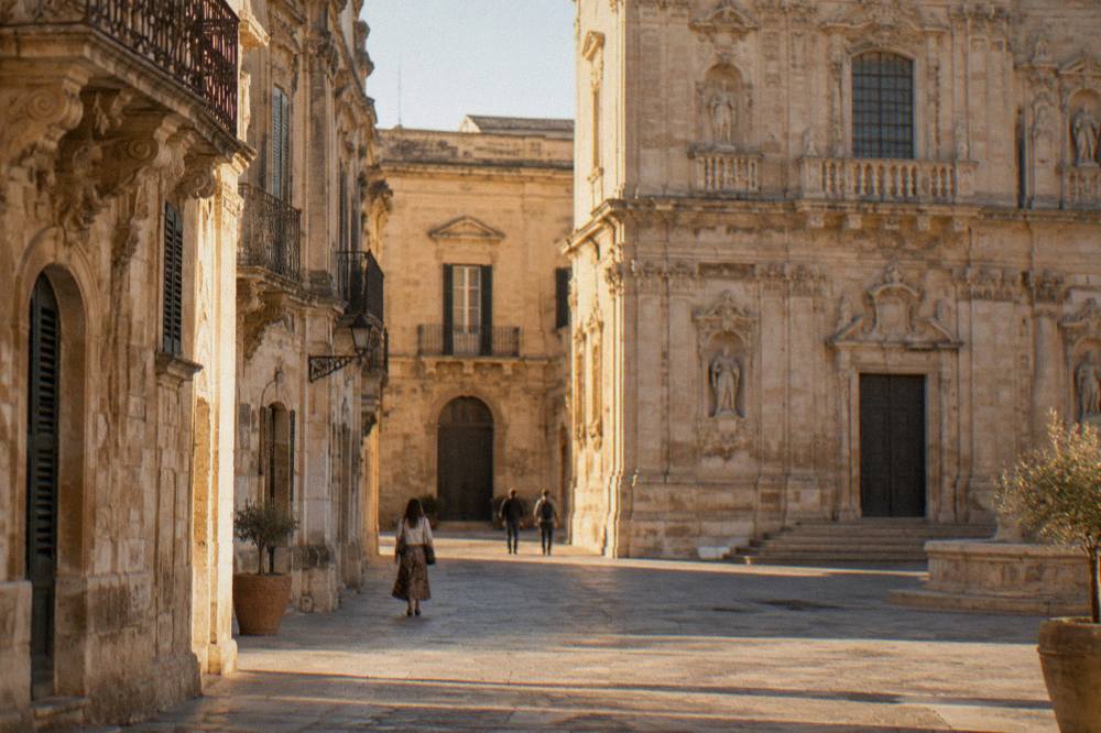 A carved limestone facade in golden evening light in a baroque square in Lecce