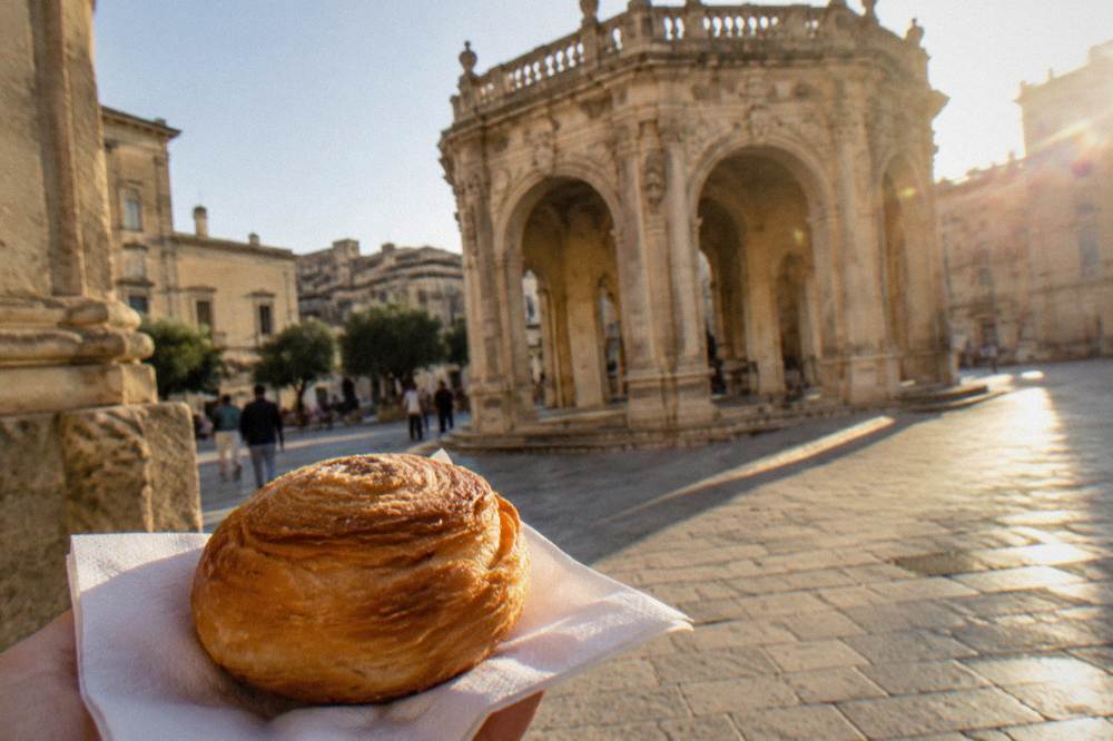 Round puff pastry snack on a paper napkin, no labels