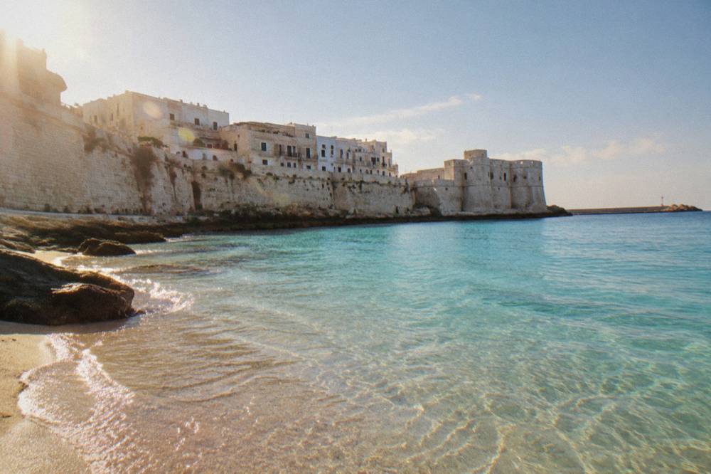 Turquoise shallow water over fine sand on an Ionian beach in Salento