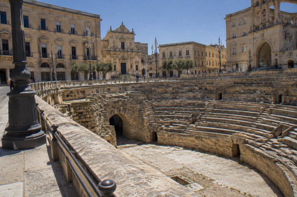 The sunken Roman amphitheatre in Piazza Sant'Oronzo seen from street level in Lecce