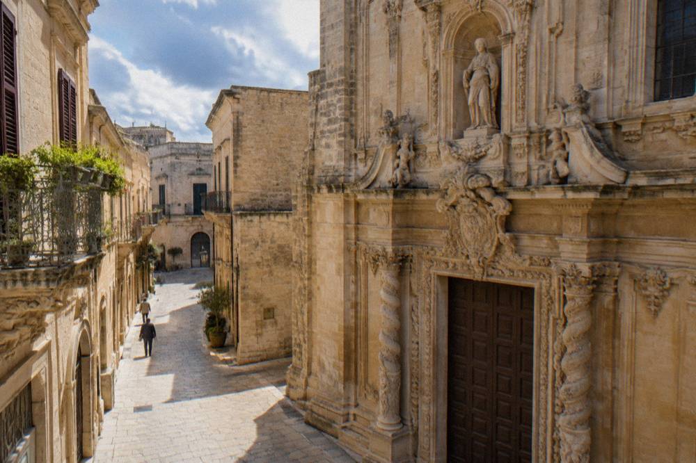 A carved baroque doorway detail on a side-street church in Lecce's old town