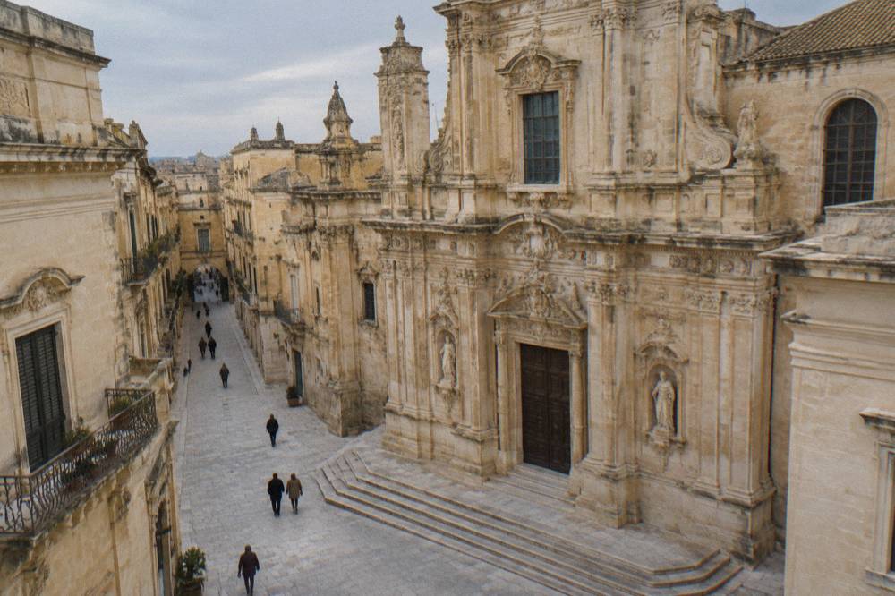 The ornate baroque facade of a Lecce basilica carved in pale golden stone