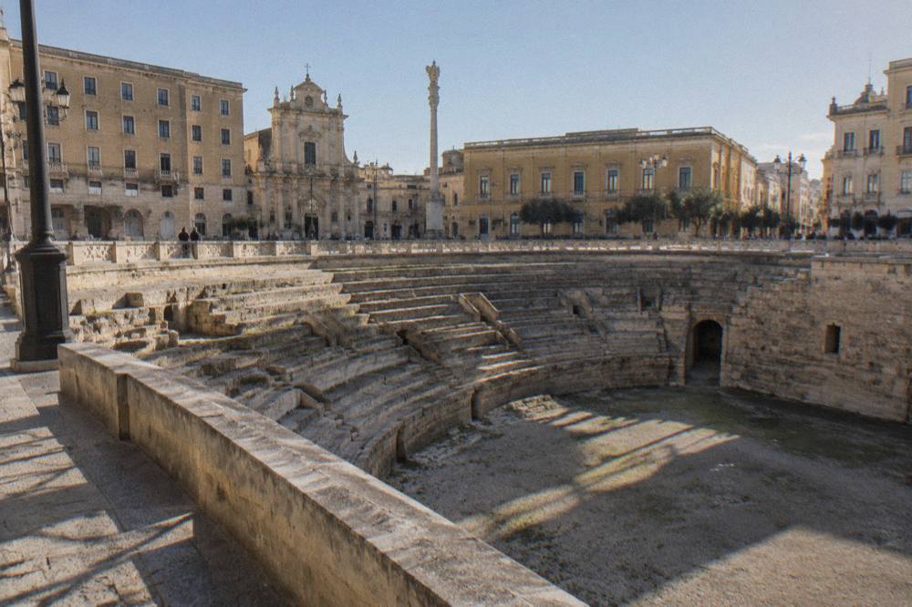 The sunken Roman amphitheatre seen from the edge of Piazza Sant'Oronzo in Lecce
